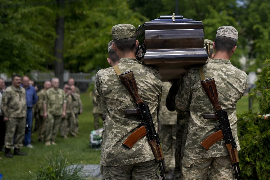 Ukrainian servicemen carry the coffin with the remains of Army Colonel Oleksander Makhachek during his funeral in Zhytomyr, Ukraine, on Friday. Photo: AP
