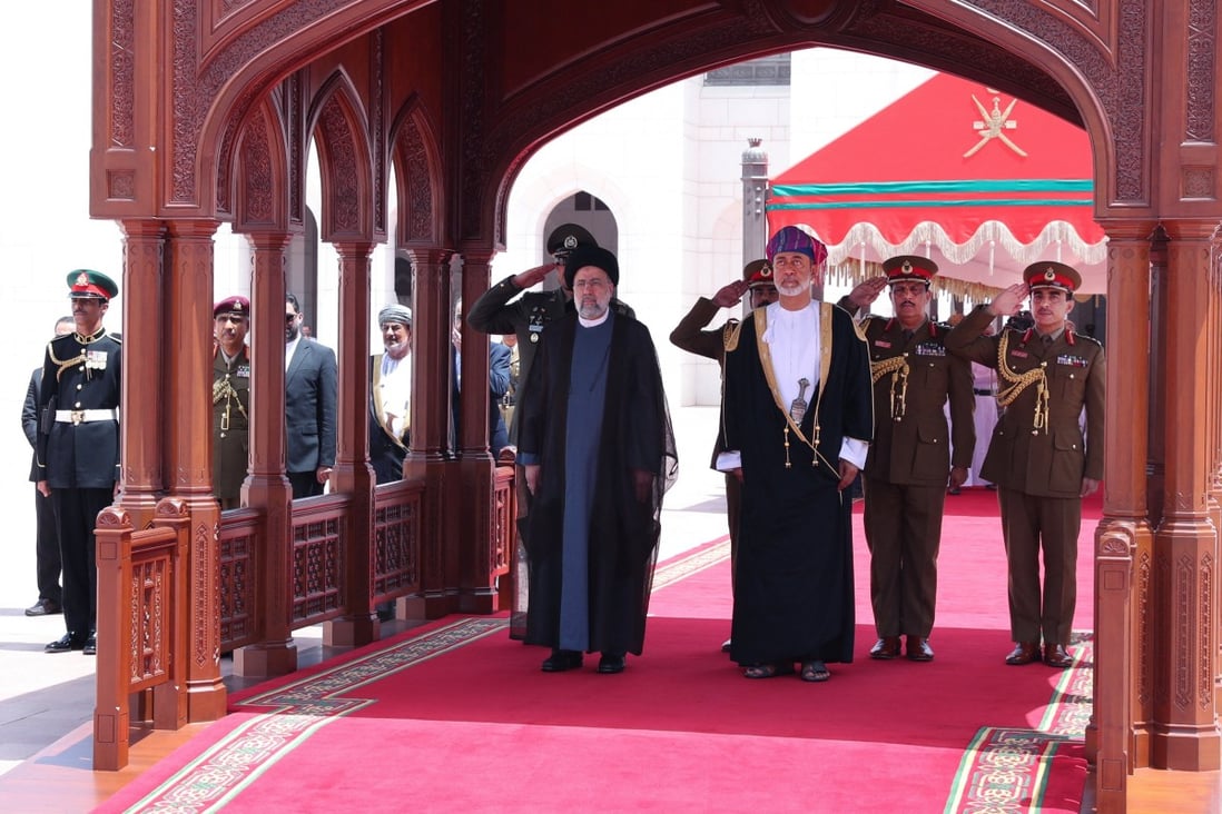 Oman’s Sultan Haitham bin Tariq stands with Iran’s President Ebrahim Raisi during a welcoming ceremony in Muscat, Oman, on May 23. Photo: Official Presidential Website / Handout via Reuters