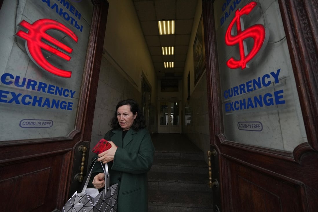 A woman leaves a currency exchange office in St Petersburg, Russia. Photo: AP