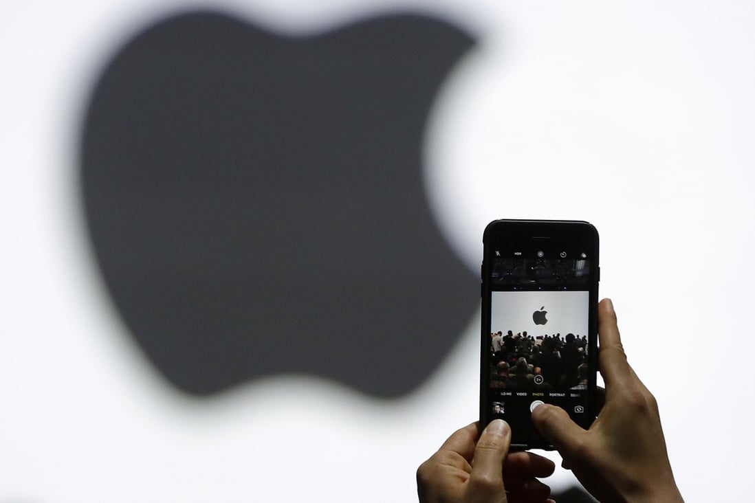 A person takes a photo of an Apple logo before an announcement of new products on June 5, 2017. Photo: AP