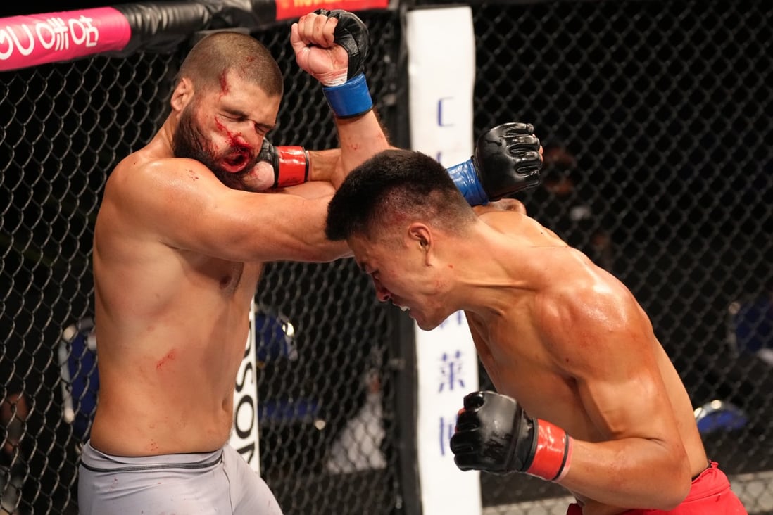 Zhang Mingyang of China punches Tuco Tokkos during the Road to UFC event at Singapore Indoor Stadium on June 9, 2022 in Singapore. Photo: Zuffa LLC