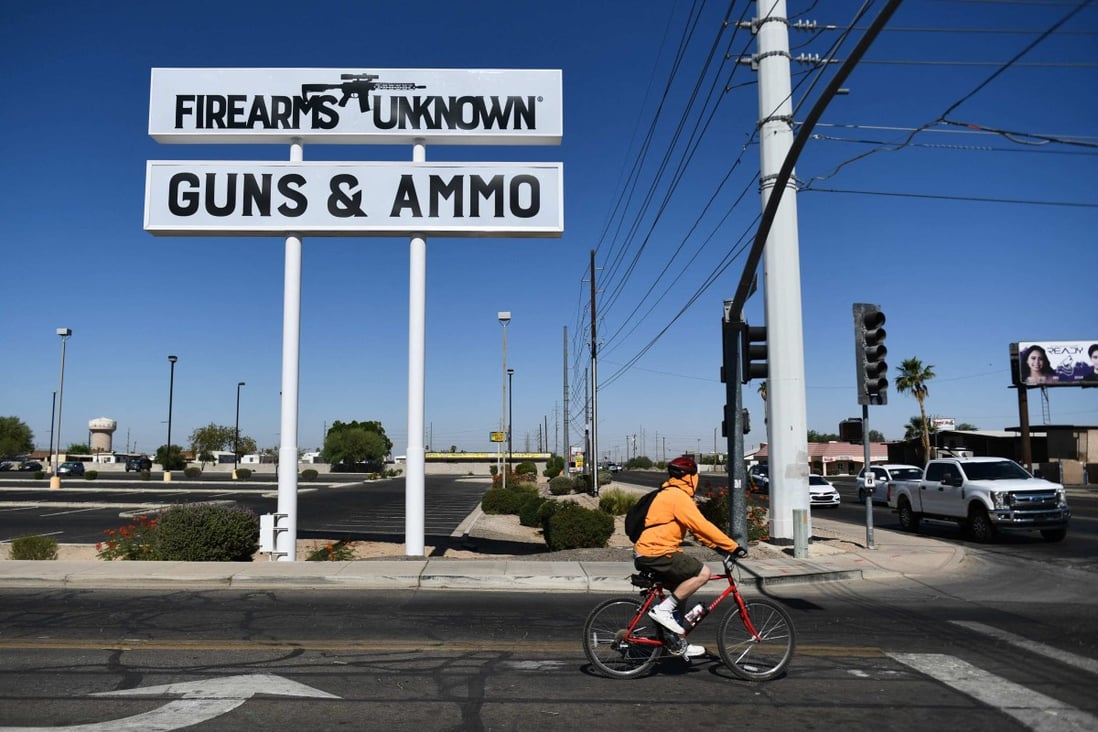 A sign for a firearms store is displayed in Yuma, Arizona, on June 2. US President Joe Biden has urged lawmakers to ban privately owned assault weapons to curb the mass shootings plaguing the country. Photo: AFP