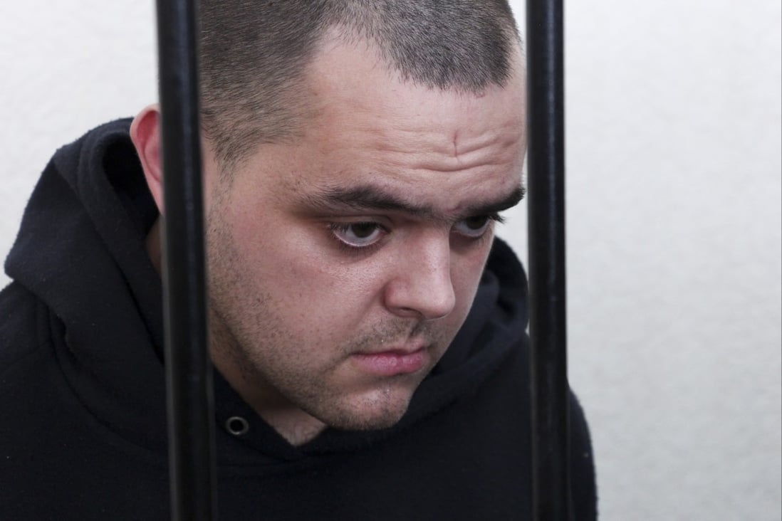 British citizen Aiden Aslin behind bars in a courtroom in Donetsk, in the territory which is under the Government of the Donetsk People’s Republic control, eastern Ukraine. Photo: AP