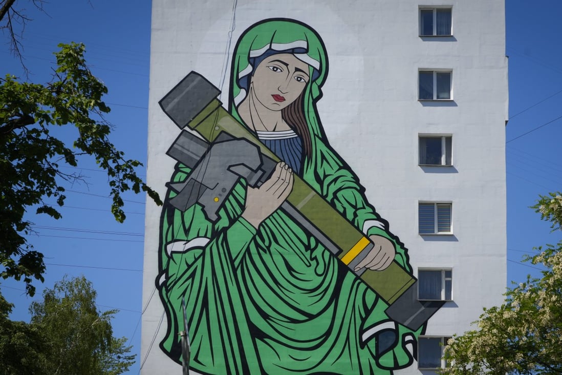 A mural in Kyiv depicts ‘Saint Javelina’ cradling a US-made Javelin anti-tank weapon. These missiles are among arms being sent by Western allies to Ukrainian forces. Photo: AP