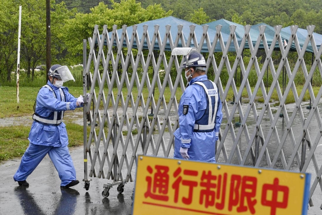 Workers open a gate in Katsurao, Japan, as evacuation orders are lifted for part of the village, near the crippled Fukushima Daiichi nuclear power plant, allowing residents to move back into their homes more than a decade on from the March 2011 disaster. Photo: Kyodo