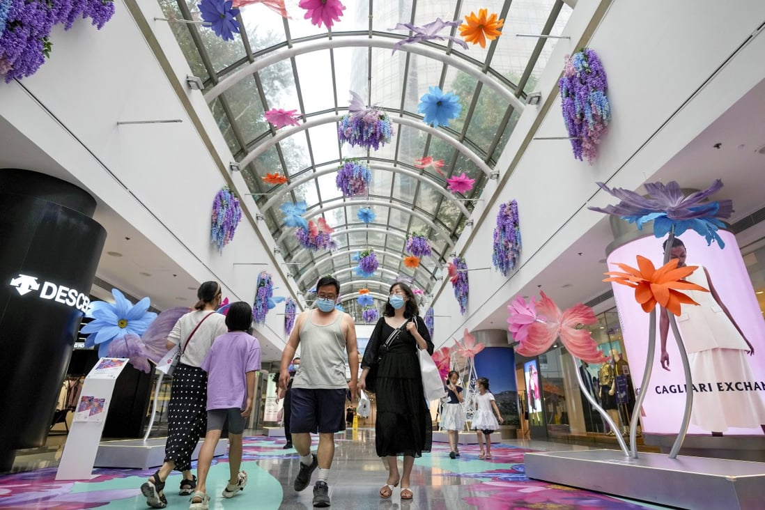Residents walk through a reopened shopping mall in Beijing on May 29, as restrictions imposed following a Covid-19 outbreak in late April are gradually lifted. Photo: AP
