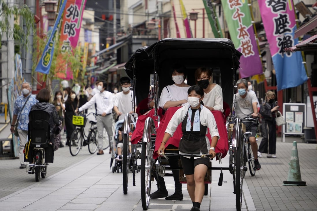 Tourists enjoy a rickshaw ride at Asakusa tourist district in Tokyo, Japan on Friday. Photo: EPA-EFE