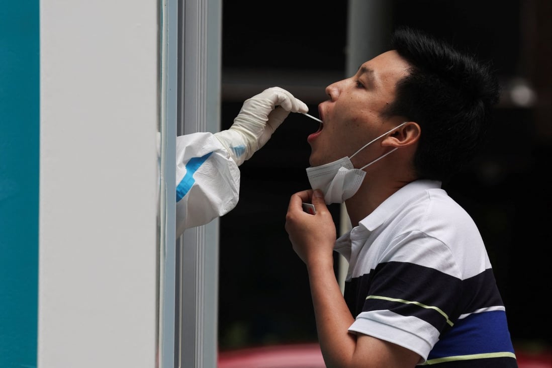 A medical worker takes a swab sample from a person at a mobile Covid-19 testing booth in Beijing on Monday.
Photo: Reuters 