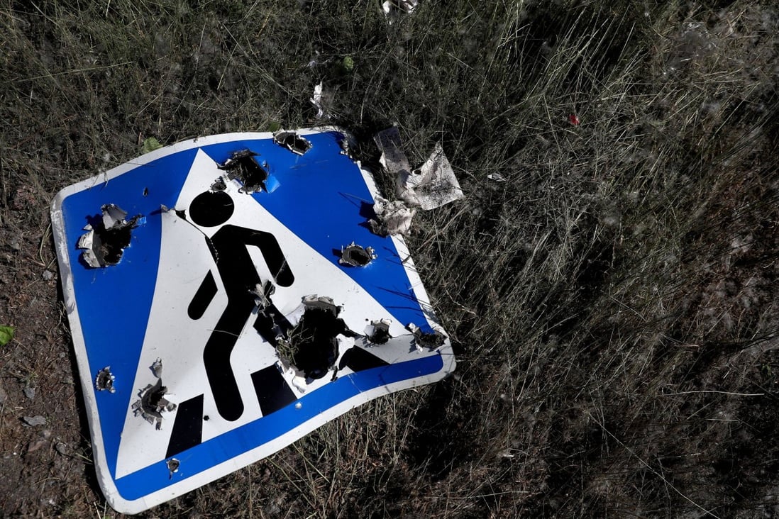 A road sign damaged by cluster munitions on the outskirts of Kharkiv, Ukraine. Photo: Reuters