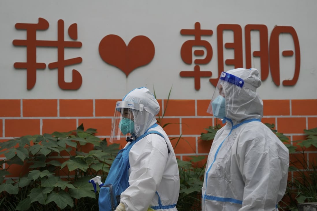 Medical workers in protective suits head to take Covid-19 samples from residents in Beijing. Photo: AP