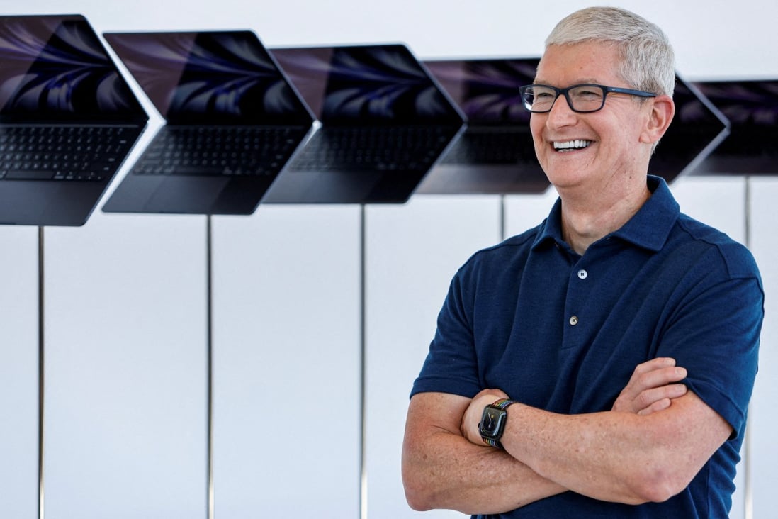 Apple chief executive Tim Cook poses in front of a row of new MacBook Airs running M2 chips on display at the opening of the tech giant’s annual Worldwide Developers Conference on June 6, 2022 at its headquarters in Cupertino, California. Photo: Reuters