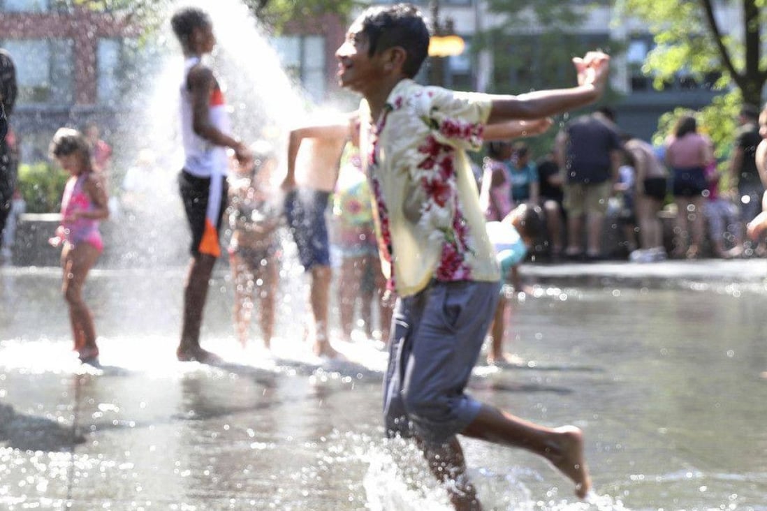 Children keep cool in the heat at the Millennium Park’s Crown Fountain, Lakeview, Chicago, on June 14. Photo: TNS