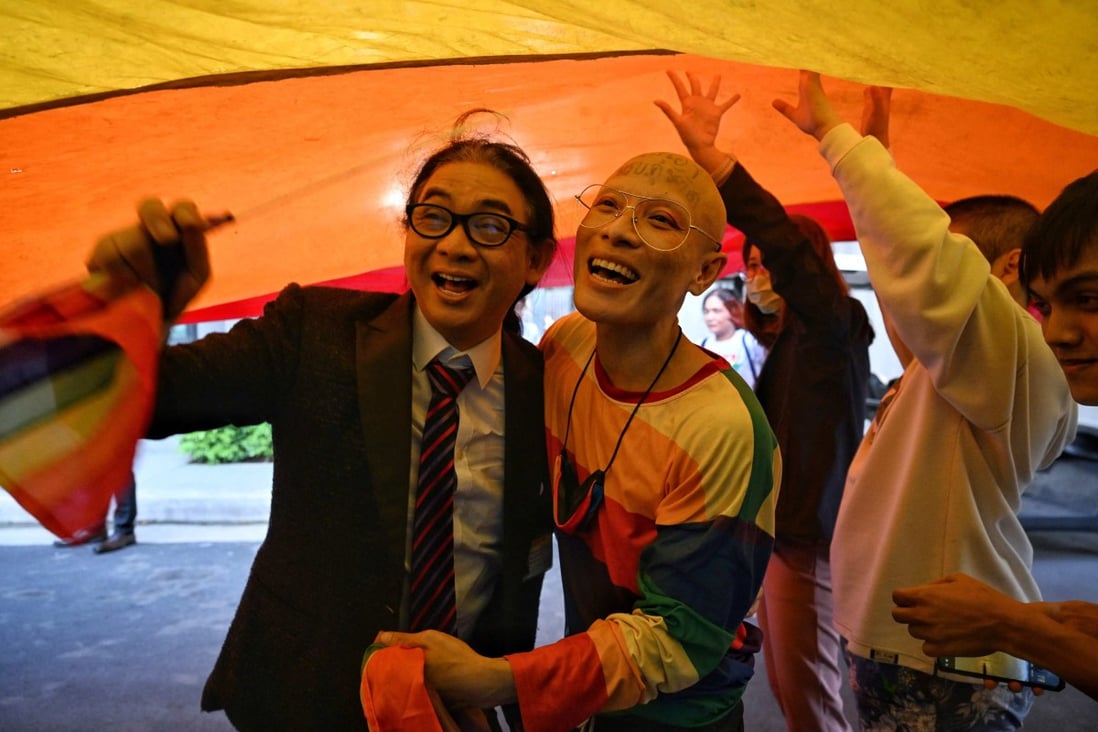 MP Thanyawat Kamolwongwat, left, celebrates with LGBT activists after the initial passing of the Move Forward Party’s marriage equality bill in Bangkok on Wednesday. Photo: AFP