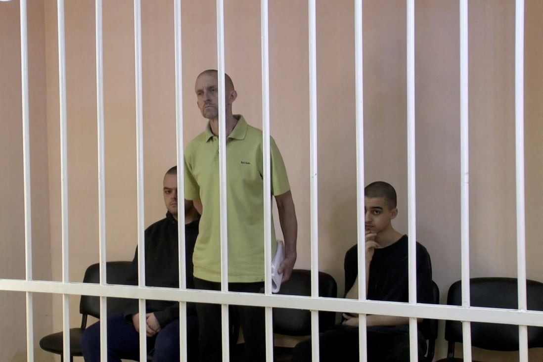 From left, Britons Aiden Aslin, Shaun Pinner and Moroccan Brahim Saadoun, captured by Russian forces during a military conflict in Ukraine, at a location given as Donetsk, Ukraine in June. Photo: Supreme Court of Donetsk People’s Republic / Handout via Reuters TV