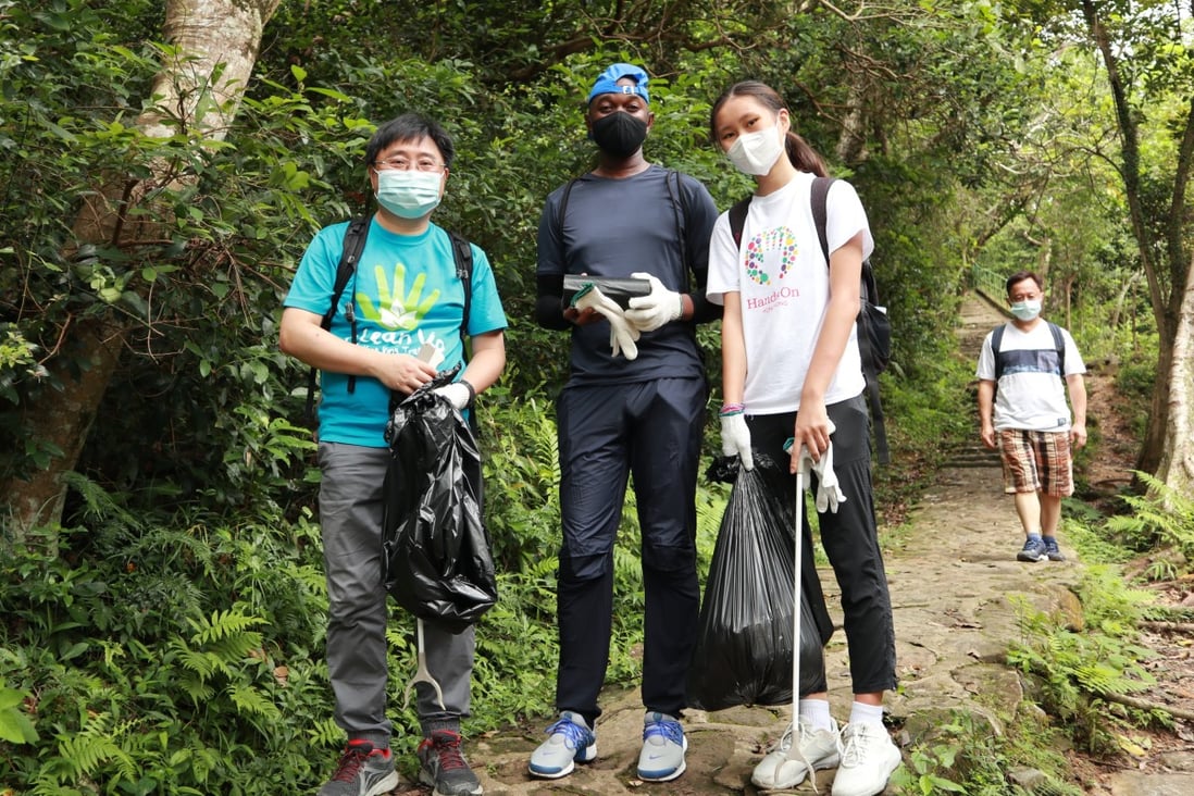 Faith Hui (right) and other volunteers help clear trash from the Little Hawaii Trail in Hong Kong during Serve-a-thon, an annual community-service week run by local volunteer charity HandsOn. Photo: HandsOn Hong Kong
