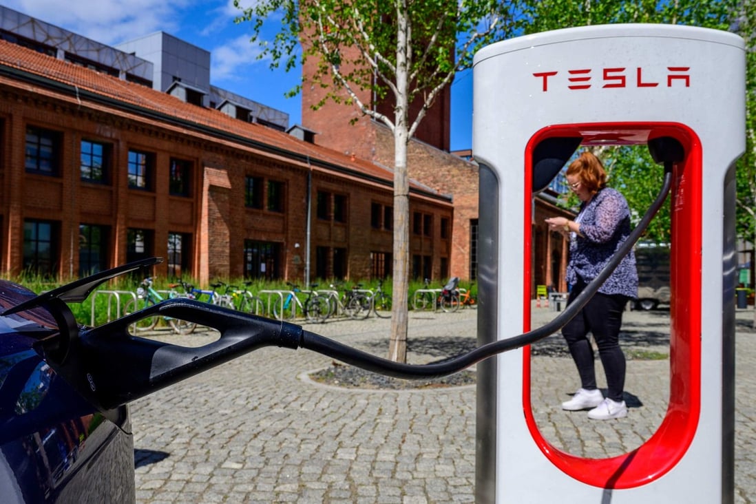 A Tesla electric car is charged in Berlin on May 27. Tesla, a company at the forefront of making technological breakthroughs to reduce the use of fossil fuels, has been dropped from the S&P 500 ESG index. Photo: AFP 