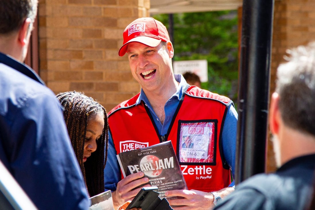 Britain’s Prince William poses for a picture with a vendor of The Big Issue newspaper to promote it s charitable cause in June. Photo: Reuters