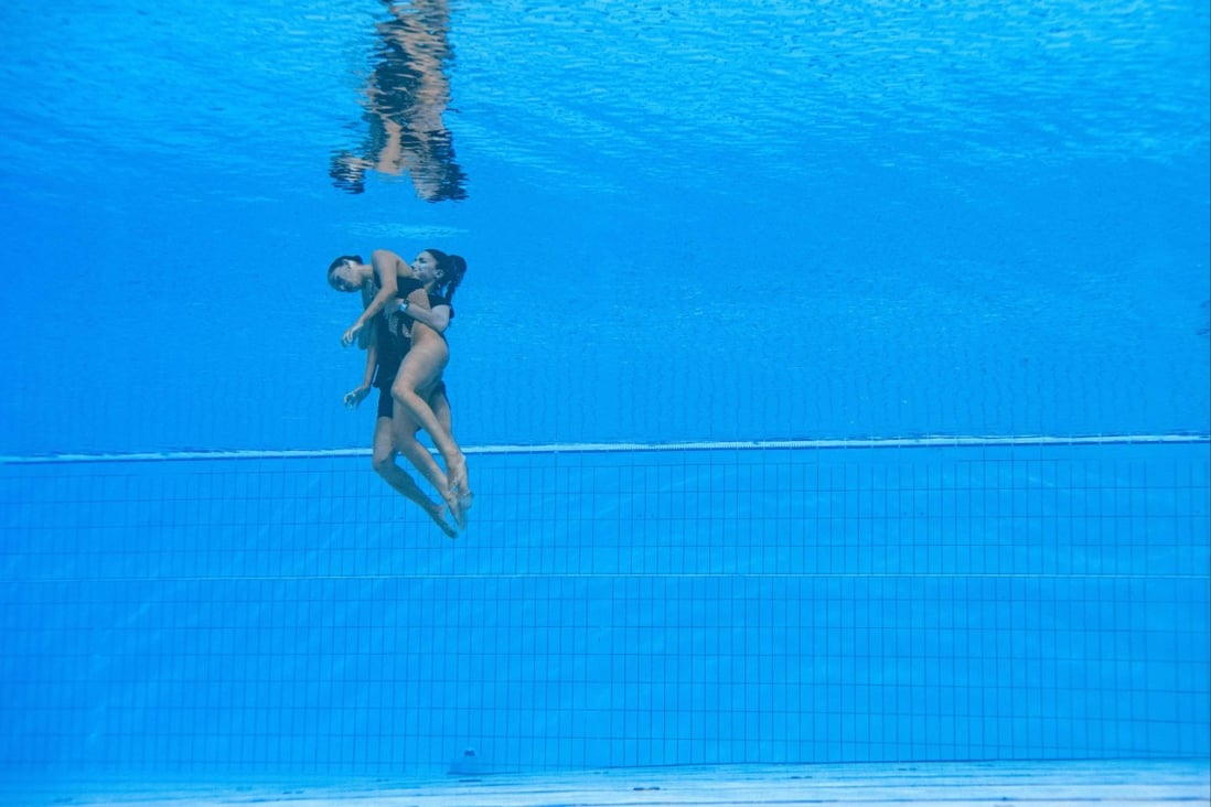 Anita Alvarez is recovered from the bottom of the pool by head coach Andrea Fuentes. Photo: AFP