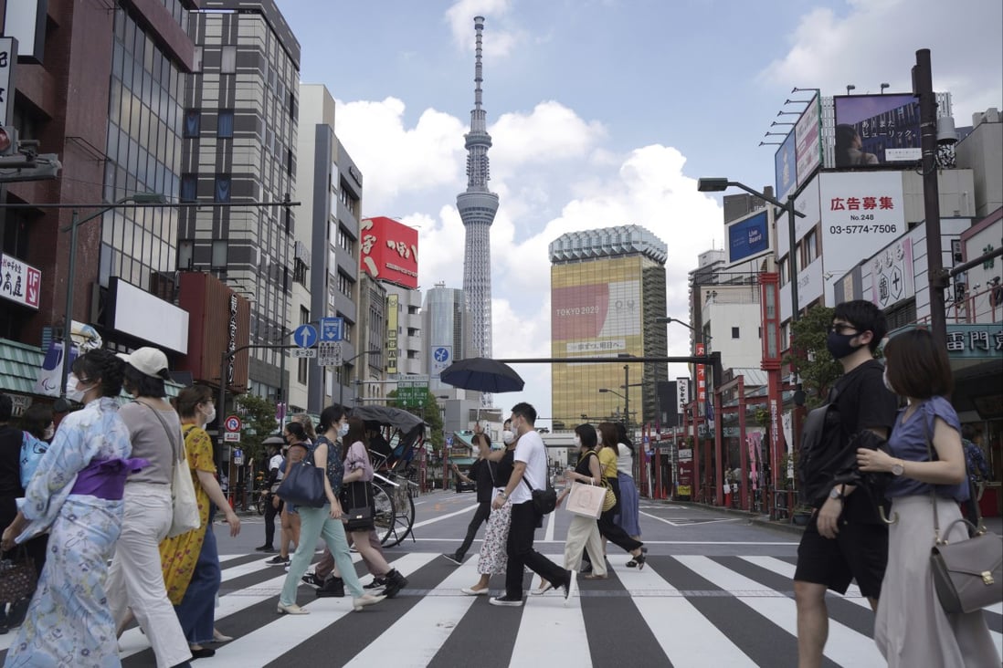 People walk along a pedestrian crossing in Asakusa, near the landmark Tokyo Skytree tower in Tokyo. Japan reopened its borders to foreign tourists for the first time in about two years from June 10, 2022. Photo: AP Photo