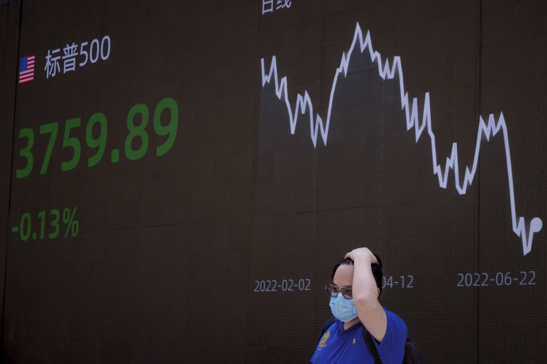A man stands in front of the jumbo screen showing the latest economic and stock data in Shanghai on June 23. Photo: EPA-EFE