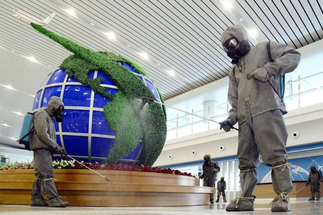 Workers disinfect the interior of Pyongyang International Airport as part of the country’s anti-coronavirus measures. Photo: KCNA via KNS/AFP