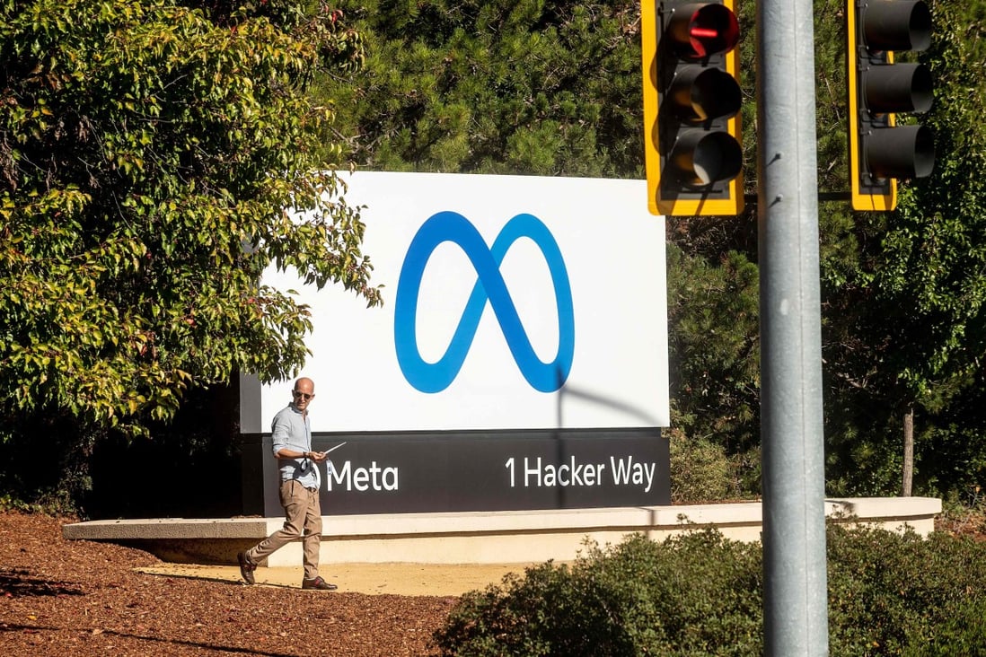 In this file photo taken on October 28, 2021, a man passes a newly unveiled logo for Facebook parent company Meta Platforms. Photo: AFP