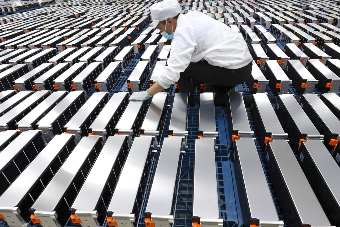 A worker with car batteries at a factory for Xinwangda Electric Vehicle Battery Co,  which makes lithium batteries for electric cars and other uses, in Nanjing Jiangsu province. Photo: AFP