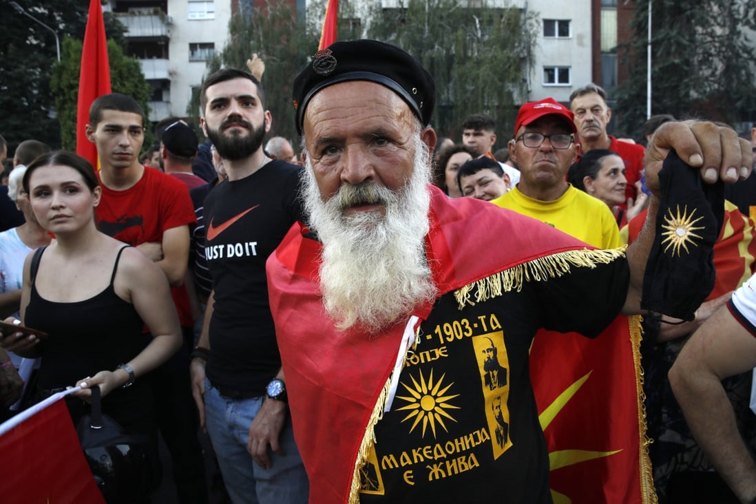A protester wearing a shirt, reading in Macedonian “Macedonia is alive” attends a protest in front of the government building in Skopje, North Macedonia on Saturday. Photo: AP