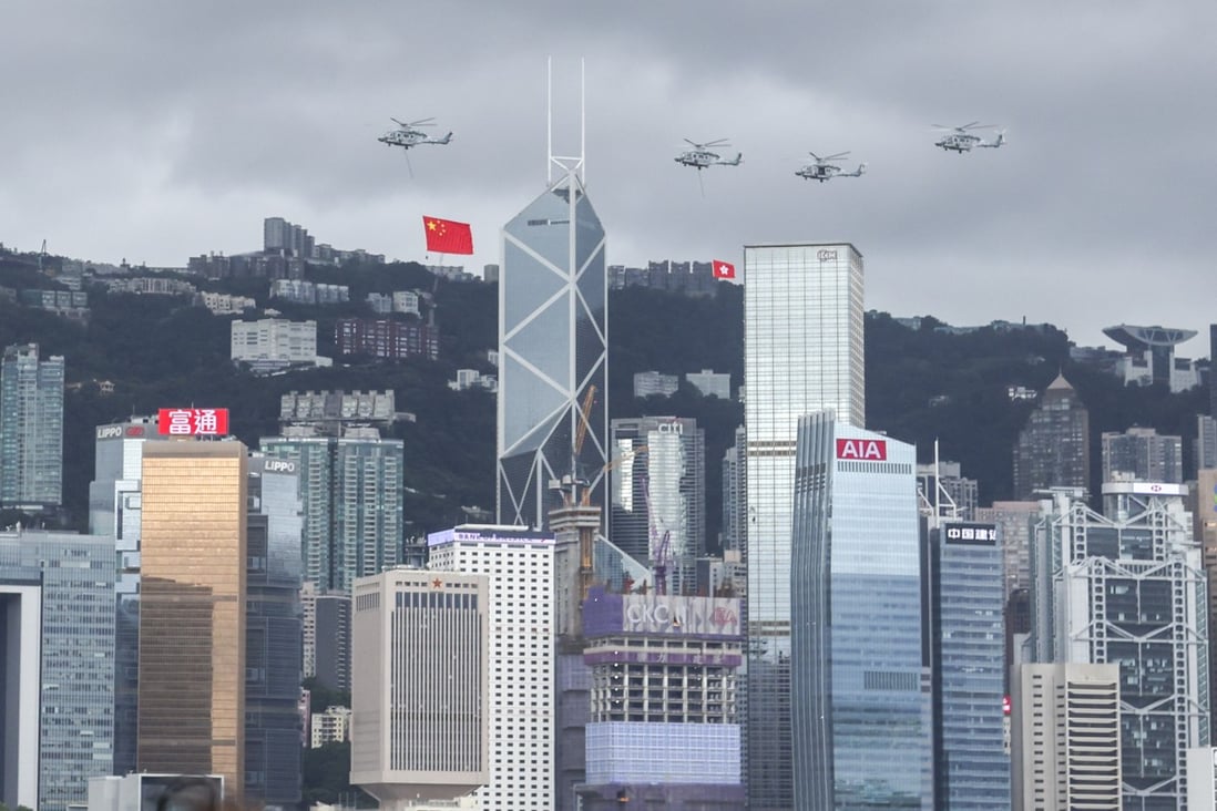 Helicopters flew China’s national flag and the Hong Kong Special Administrative Region’s standard over Central district to mark the 25th anniversary of Hong Kong’s handover to Chinese rule on 1 July 2022. Photo: Nora Tam.