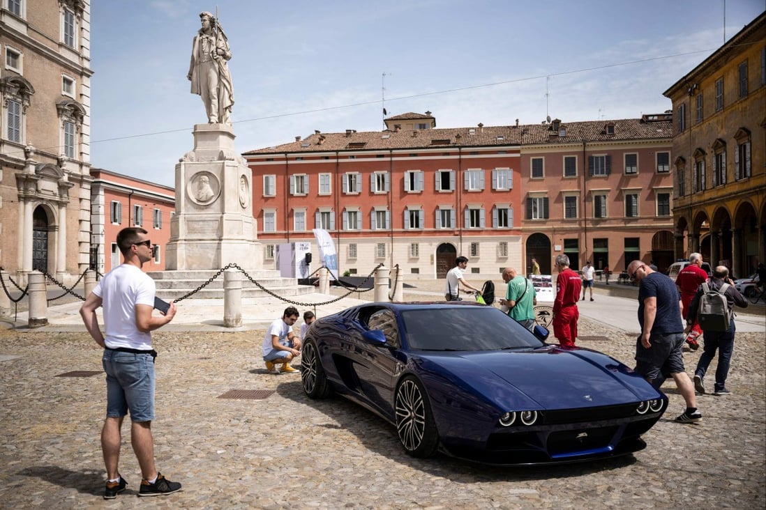 People look at a TS Automobili M67 during a fair for luxury and sports vehicles in Modena in northern Italy on May 27. Italy’s persistent low growth and high debt-to-GDP ratio make it a potential flashpoint of global financial instability. Photo: AFP