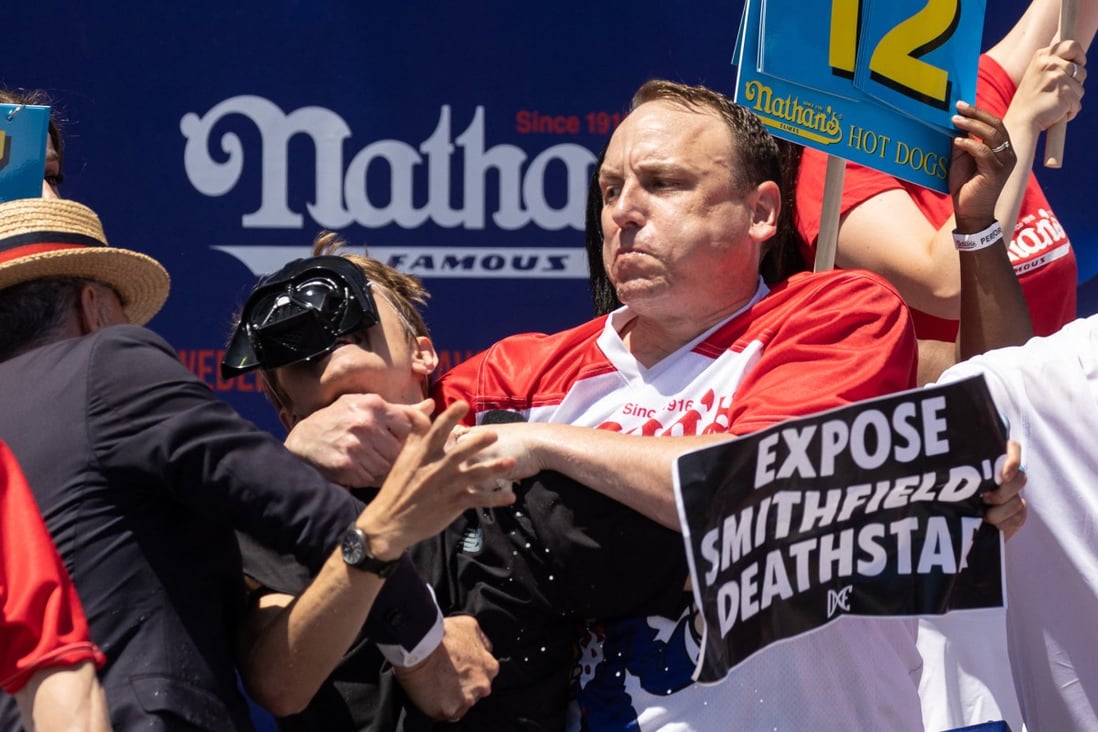 Competitive eater Joey Chestnut put a protester in a chokehold during a