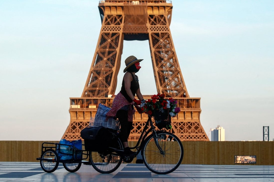A woman rides her bicycle near the Eiffel Tower in Paris in April 2021. Photo: Reuters