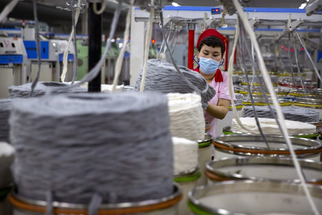 A worker gathers cotton yarn at a textile manufacturing plant in China’s Xinjiang Uygur autonomous region. Photo: AP