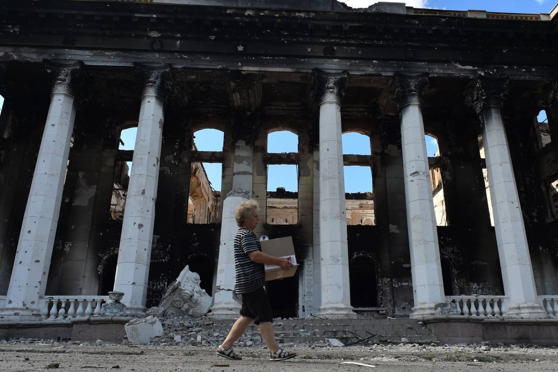 A resident walks past destroyed buildings in the city of Lysychansk, Ukraine, on July 12. Photo: AFP