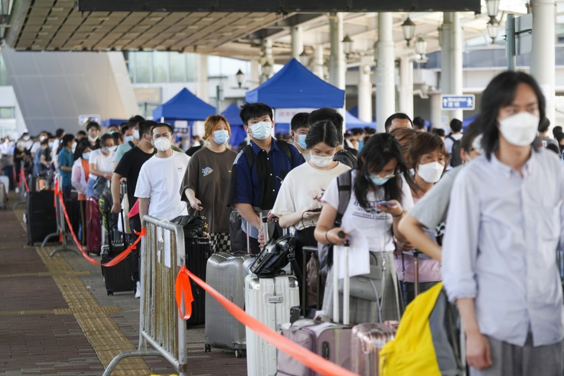 Travellers queue up at the departure hall of Shenzhen Bay Port. Officials say that booking PCR tests online could help shorten waiting times at the border. Photo: Sam Tsang