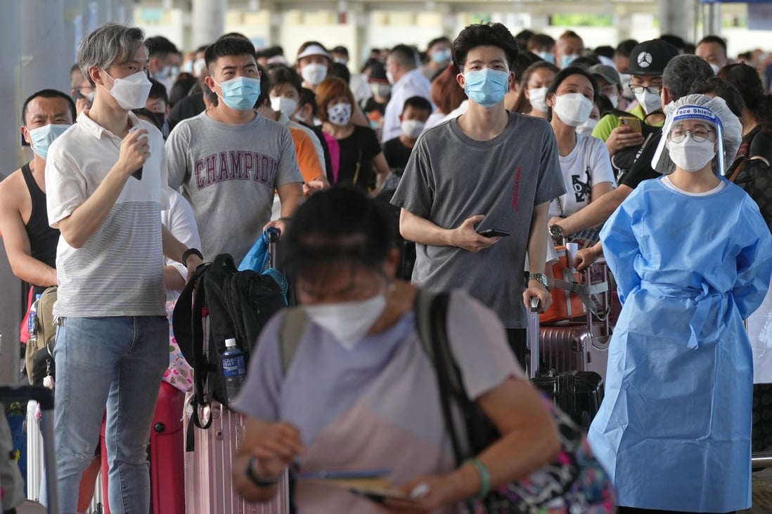 Travellers queue up at the departure hall of Shenzhen Bay Port. Officials warned of rather long waits for Covid-19 tests at the Shenzhen Bay Control Point, urging travellers to avoid going there until later in the day.   10JUL22   SCMP / Sam Tsang