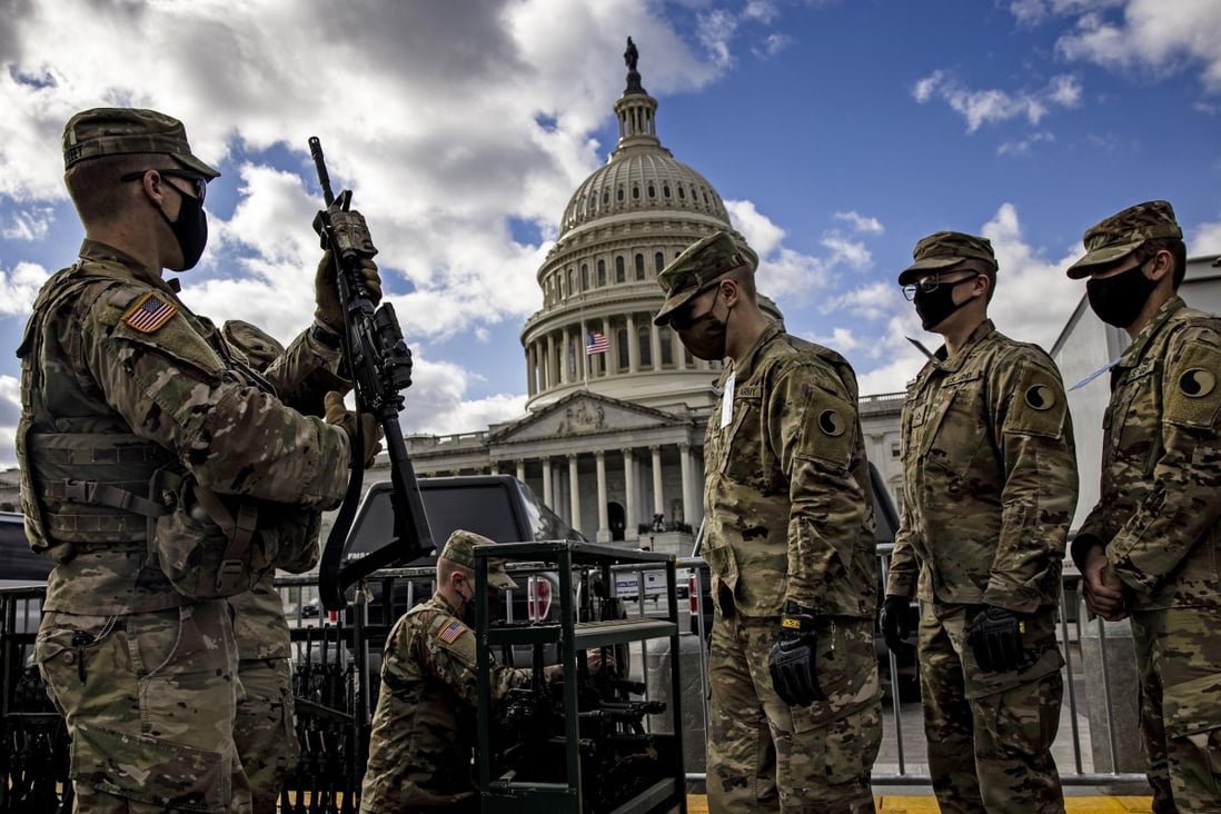 National Guard troops are issued rifles and ammunition outside the US Capitol building in January last year. The State Partnership Programme is run by the US National Guard. Photo: Samuel Corum/Getty Images/TNS