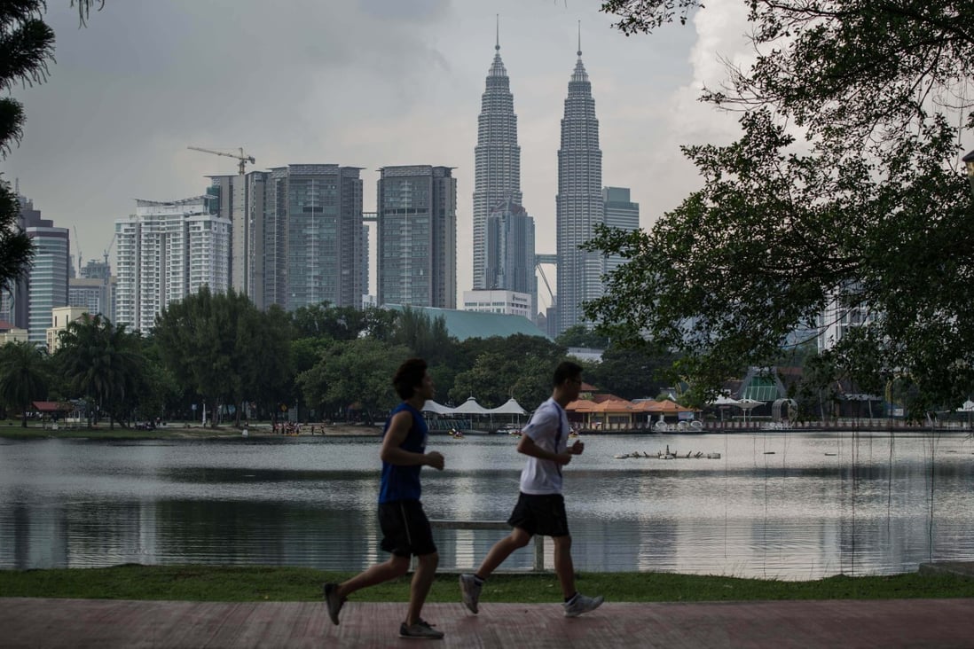 People jog in a park in Kuala Lumpur, Malaysia. The heirs of a 19th century sultan are seeking to seize Malaysian government assets around the world.  File photo: AFP
