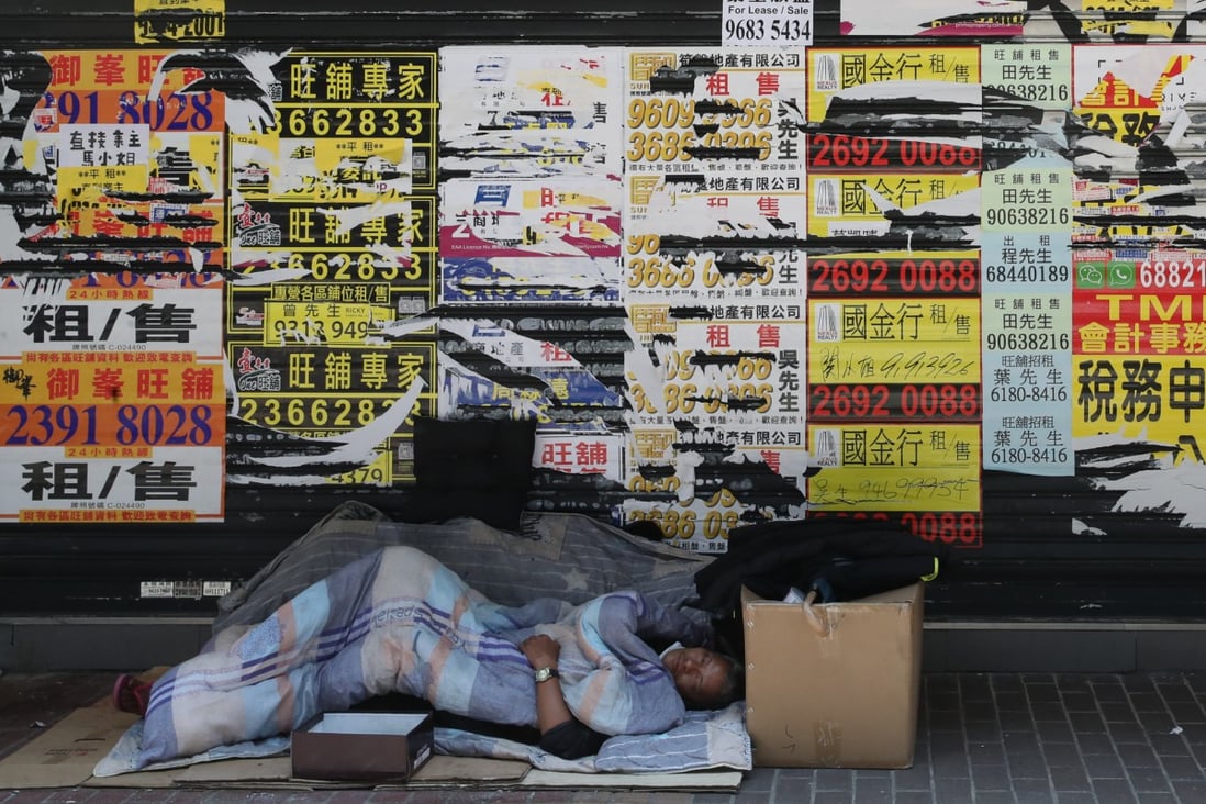 A homeless person sleeps in front of closed retail shops in Mong Kok on April 15. Hong Kong’s wealth inequality is growing worse as the pandemic drives people who were already struggling closer to the edge. Photo: Edmond So