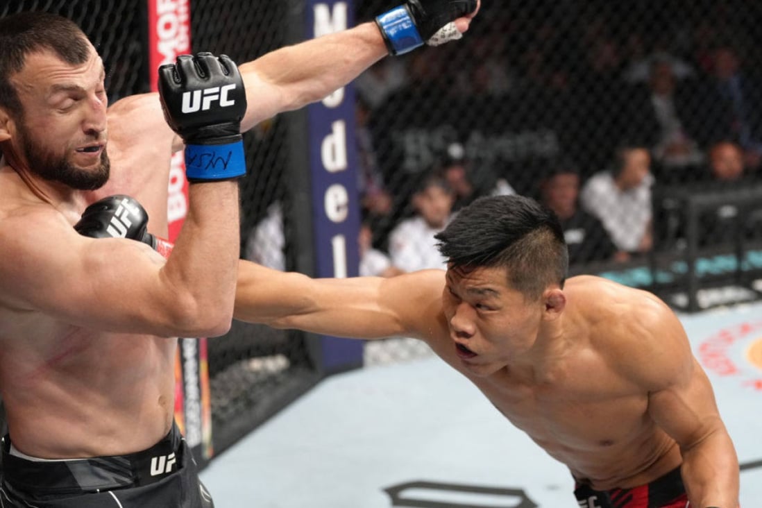Li Jingliang of China punches Muslim Salikhov of Russia in a welterweight fight at UFC Long Island. Photo: Zuffa LLC
