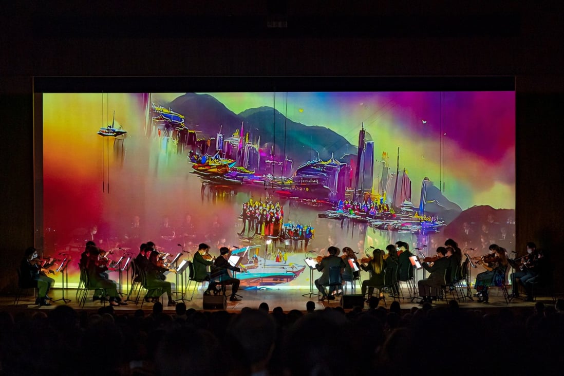 Hong Kong Baptist University’s symphony orchestra performs “Pearl of the Orient” against a video backdrop created by artificial intelligence. An AI choir and dancers also accompanied its playing.