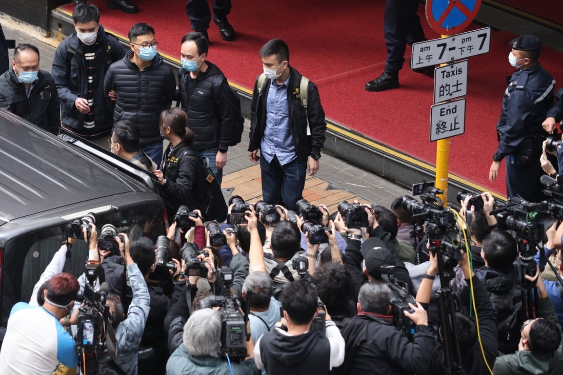 Stand News acting editor-in-chief Patrick Lam Shiu-tung being escorted to a waiting police vehicle after national security police raided his office on December 29, 2021. Photo: May Tse