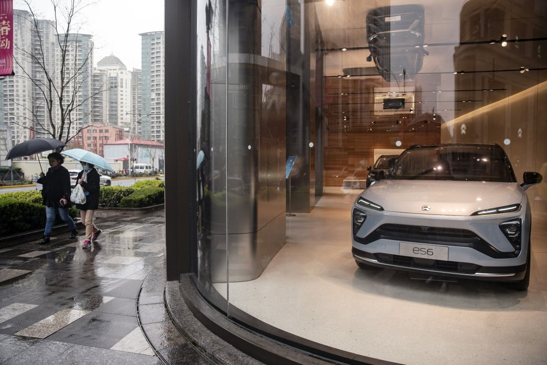 Pedestrians walk past a Nio dealership in Shanghai, China. Photo: Bloomberg