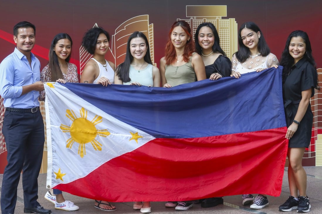 Participants in Project: “I am…“ (from second left) Marla Enriquez, Ysabelle Limsiaco, Sabrina Man, Kara Limsiaco, Reine Bucoy and Bianca Bautista, with Ray Yumul (left), president of Section Juan, which organised the project, and  Miles Sible (right), a member of Section Juan. Photo: Jonathan Wong