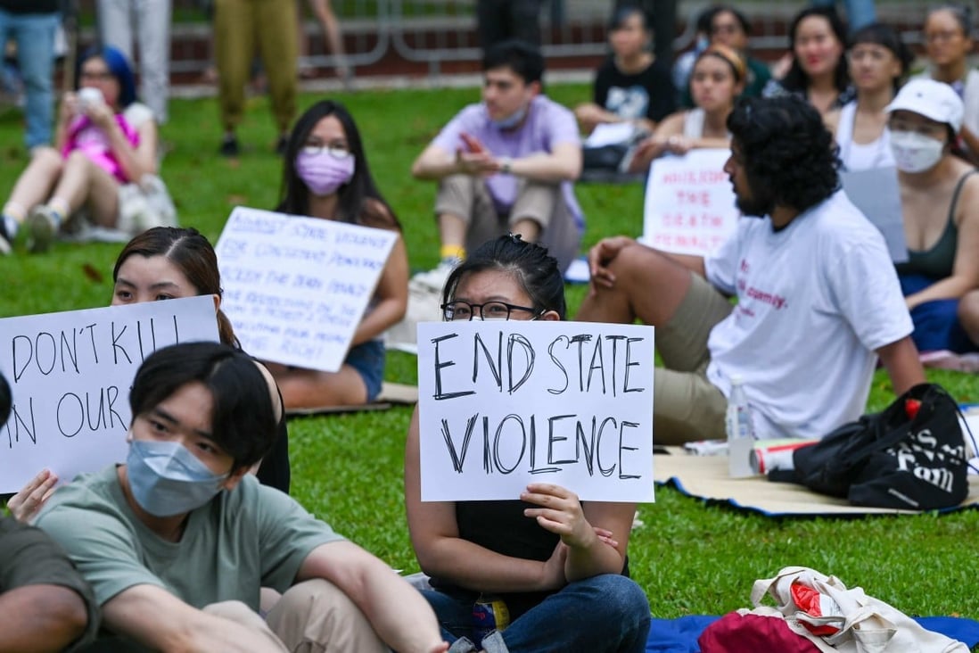 Attendees hold signs during a protest against the death penalty at Speakers’ Corner in Singapore in April. Photo: AFP