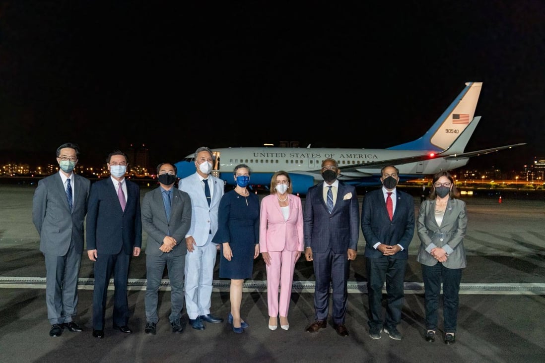 Nancy Pelosi (in pink) and her delegation pose for a picture upon their arrival at Taipei Songshan Airport. Photo: AFP