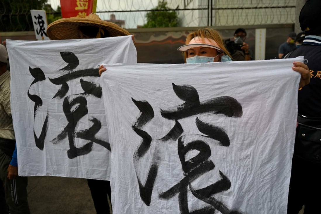 Pro-reunification activists display banners reading “Get out” as US House Speaker Nancy Pelosi visits Jing-Mei White Terror Memorial Park in New Taipei on August 3. Photo: AFP