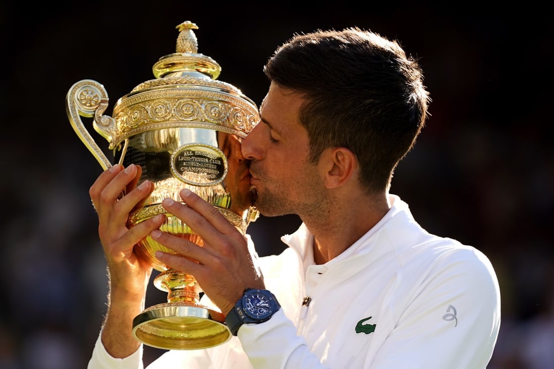 Novak Djokovic celebrates with the Wimbledon trophy after defeating Australia’s Nick Kyrgios in their men’s singles final match at the All England Lawn Tennis and Croquet Club in London on July 10. Photo: PA Wire/dpa