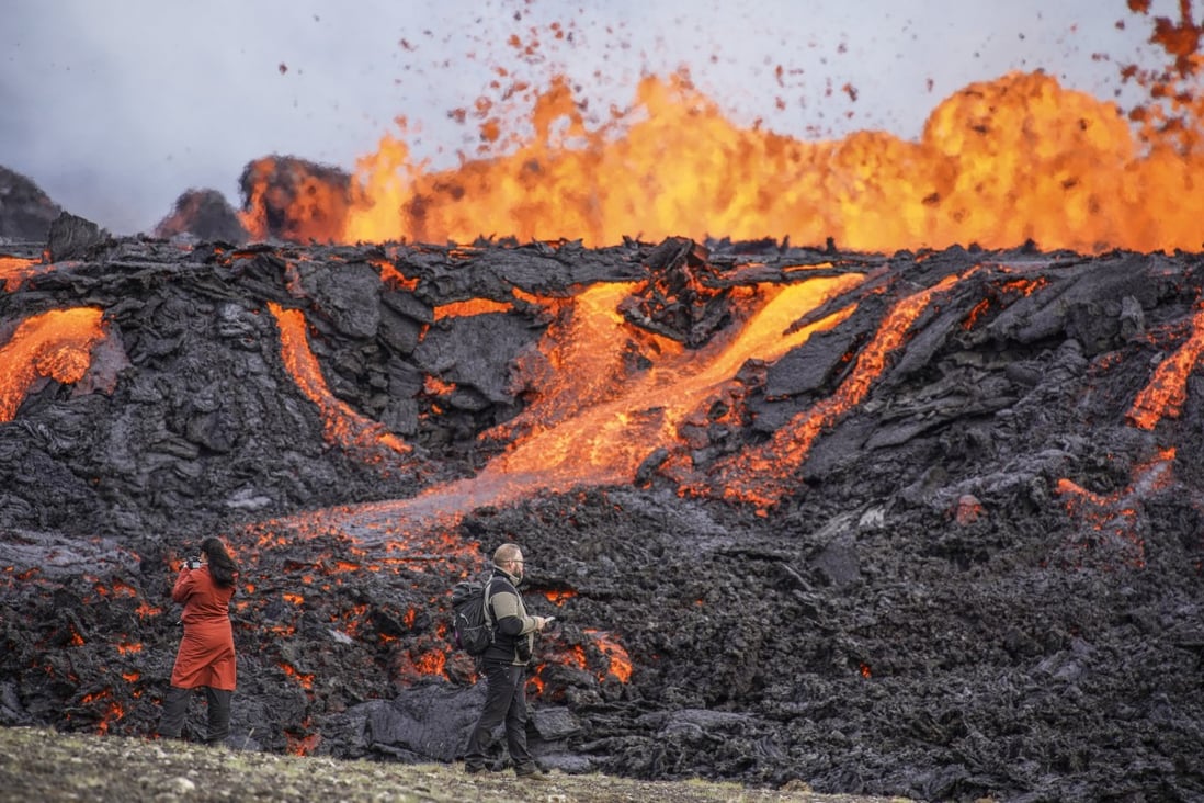 People look at the lava flowing on Fagradalsfjall volcano in Iceland on Wednesday. Photo: AP