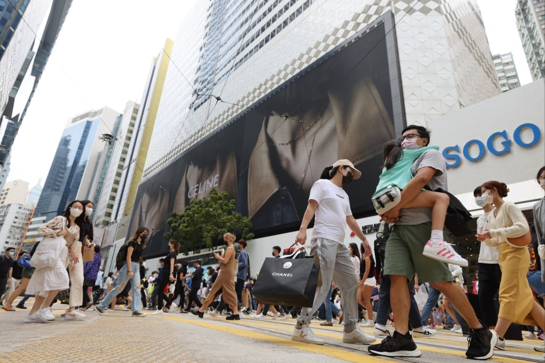People are seen crossing the road in Causeway Bay, where popular department store Sogo stands as a retailing landmark, on April 17, 2022. Photo: Nora Tam